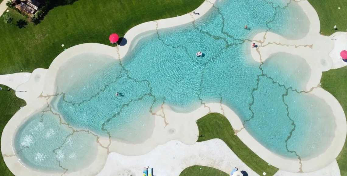 Versatile Beach Pool with a natural beach-style shape